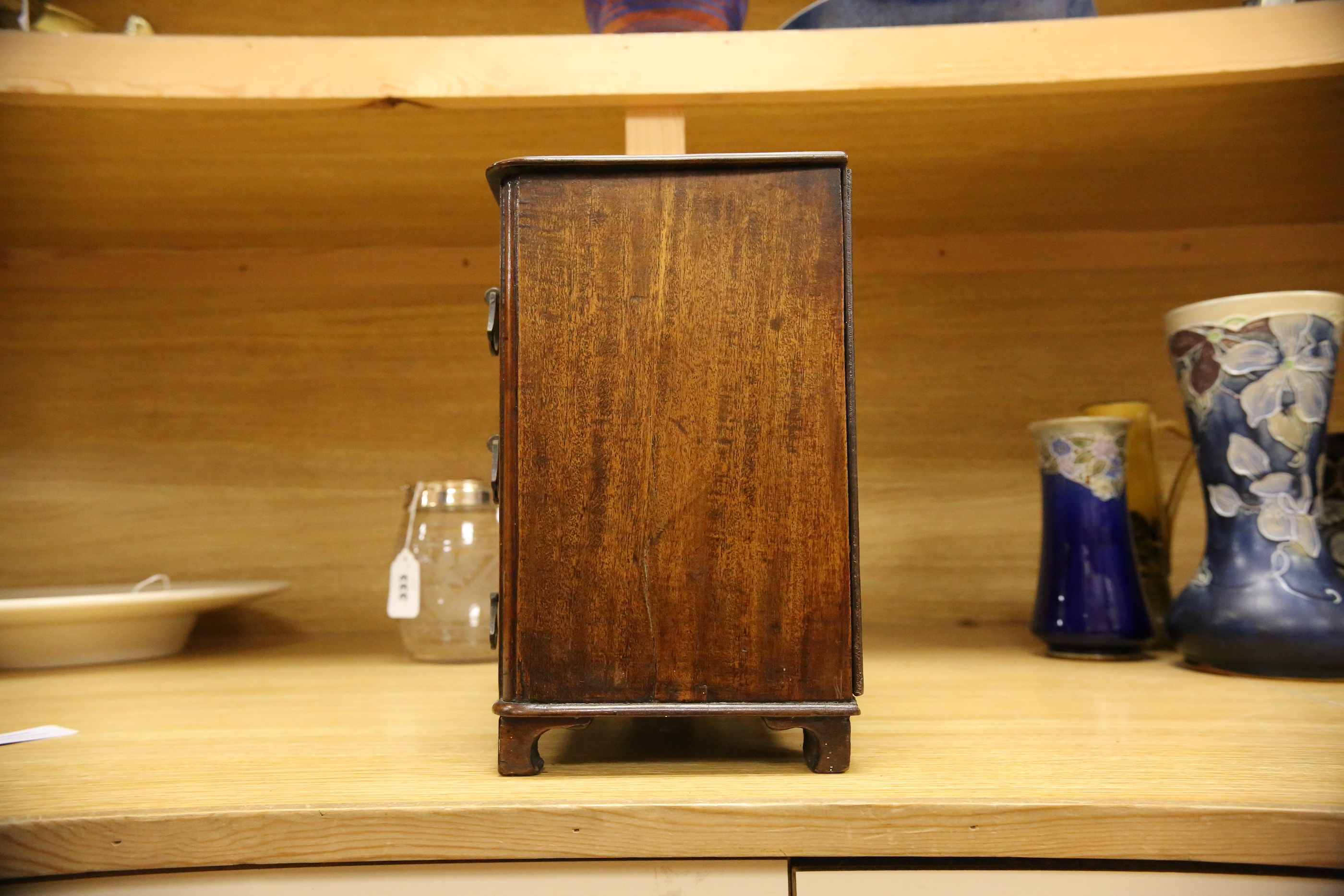 An Edwardian miniature mahogany three drawer chest, 26cm wide x 28cm high. Condition - fair to good